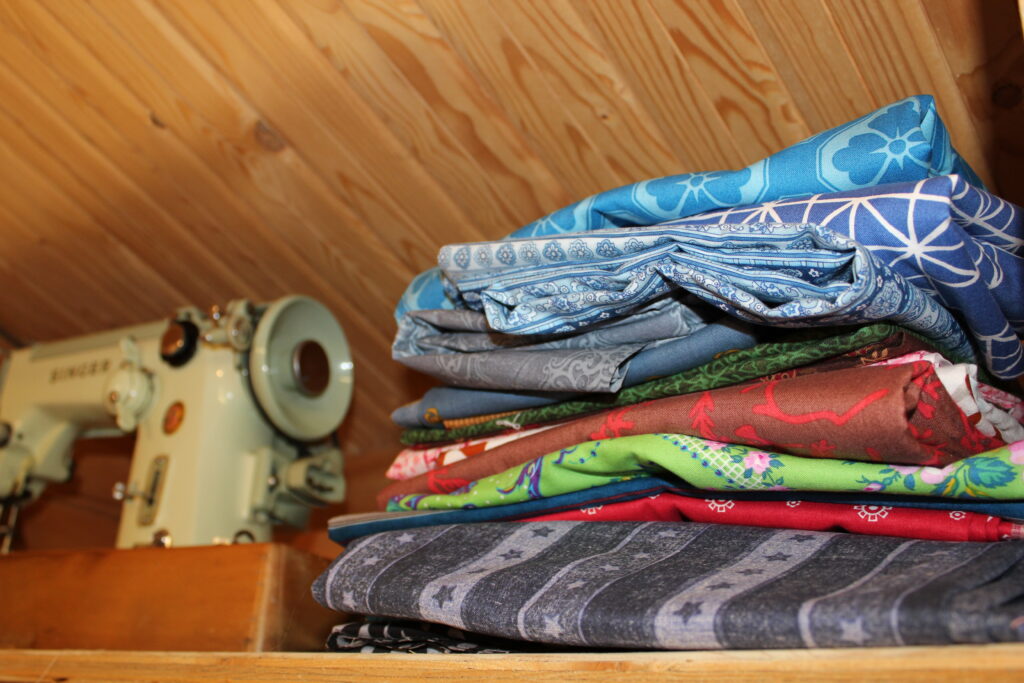 various types of quilting fabric including fat quarters jelly roll and charm pack arranged together